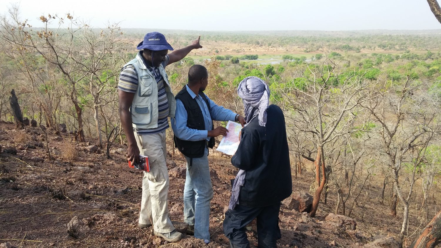 Compass geologists reviewing artisanal workings